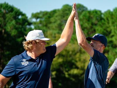 Bryson McDonald (left) and Wyatt Butcher, members of the CIU Rams golf team, celebrate. (Photo by Noah Allard)